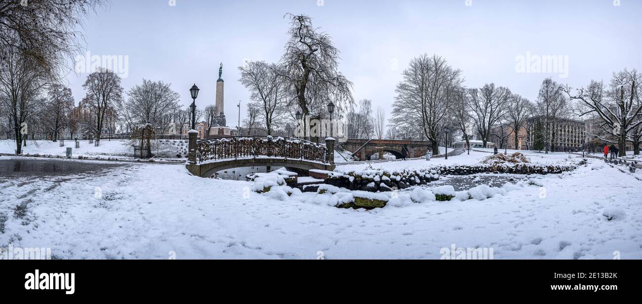 Panoramic winter landscape in snowy park with beautiful bridge over ...