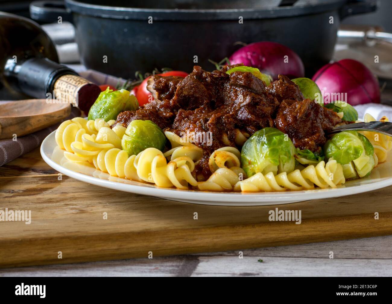Goulash with noodles and vegetables on a plate Stock Photo