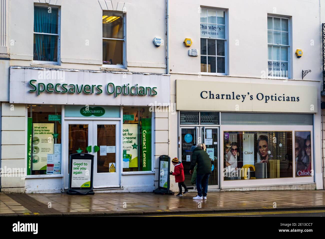 Two rival opticians side by side on Leamington Spa Parade, Warwickshire, UK. Specsavers Opticians and Charnley's Opticians. Stock Photo