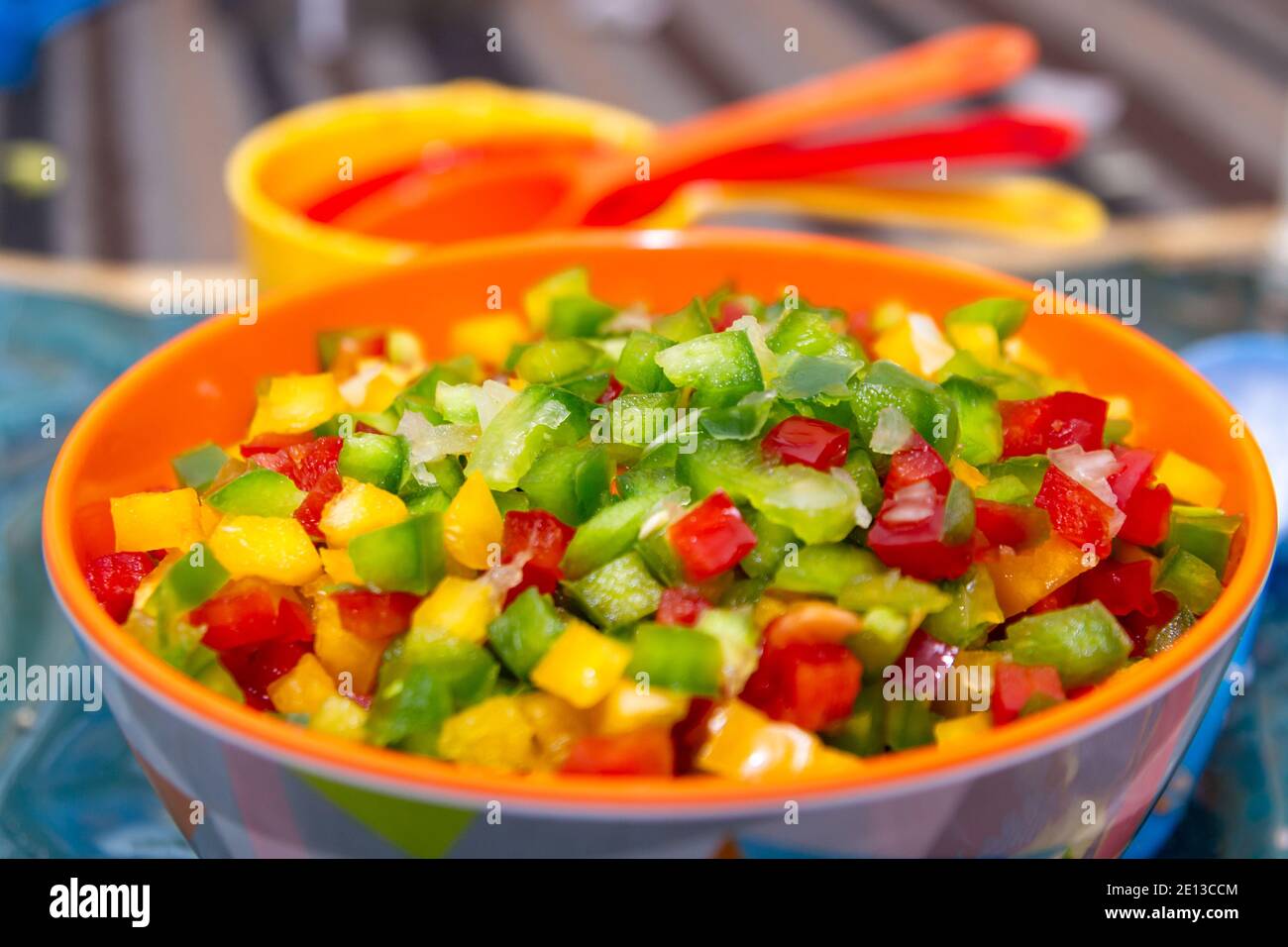 Diced capsicum peppers (bell peppers) of varying colours in a bowl Stock Photo