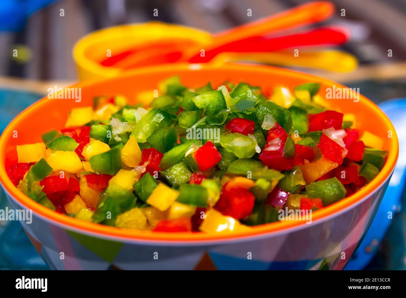 Diced capsicum peppers (bell peppers) of varying colours in a bowl Stock Photo