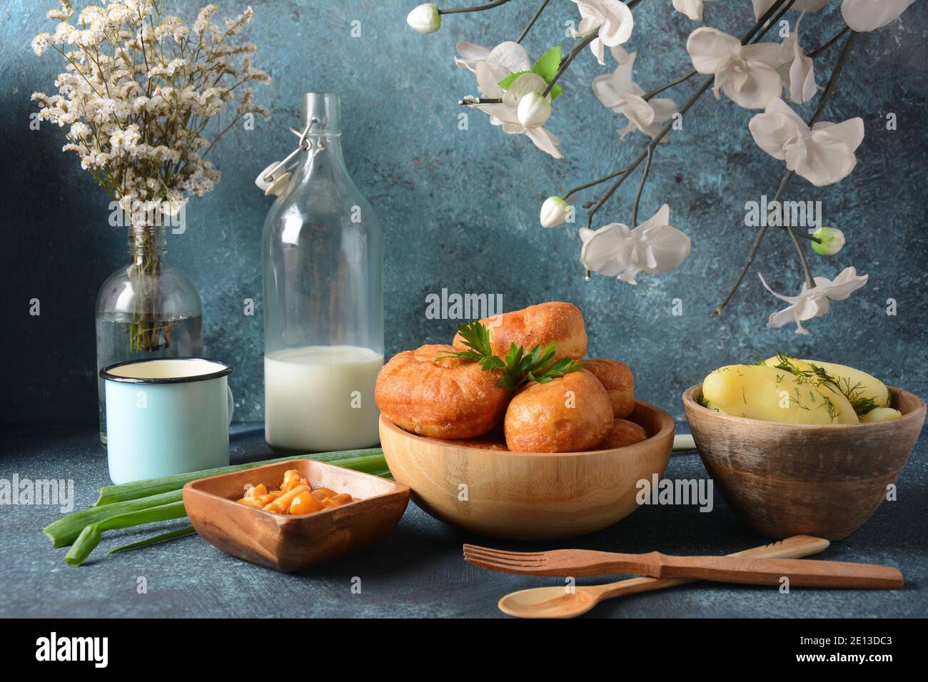Tasty breakfast rustic style. Stuffed Buns (Pirozhki) ,milk,with green