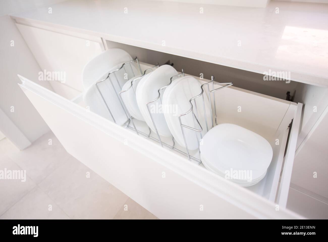 Plates in a kitchen drawer Stock Photo Alamy