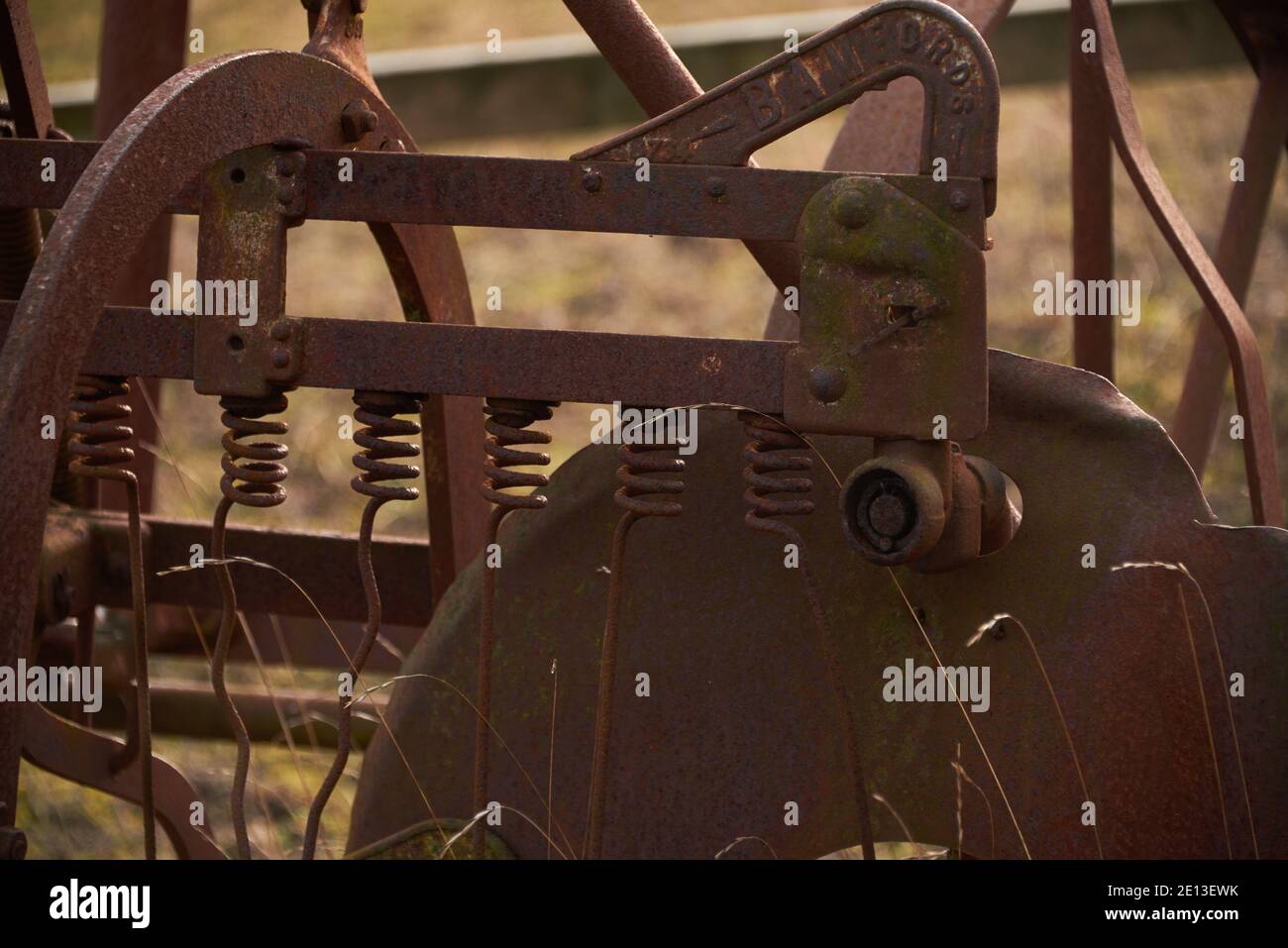Old farming machinery in field, double action haymaker Stock Photo