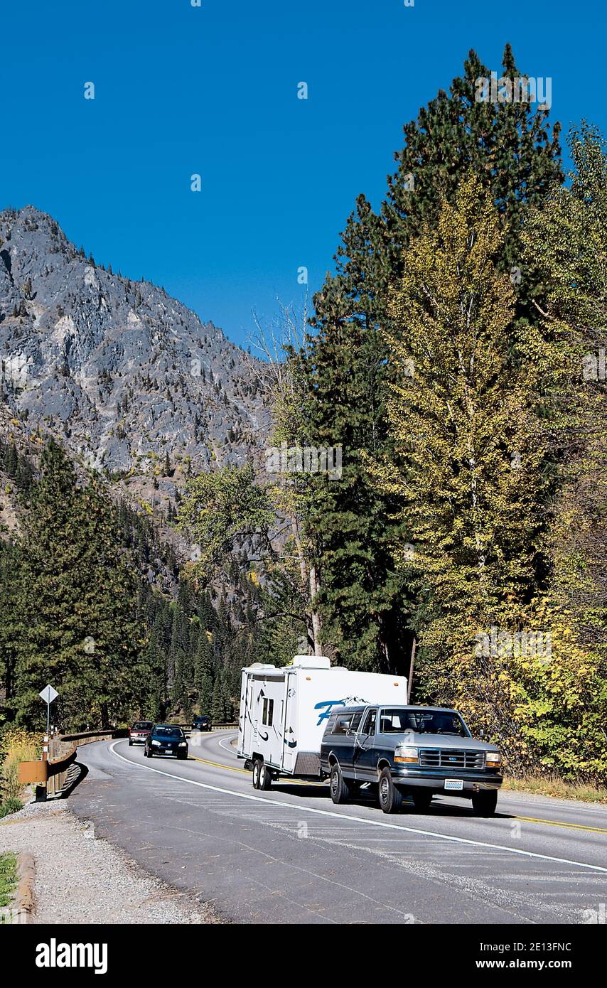 Camper Driving Through Scenic Mountains Stock Photo