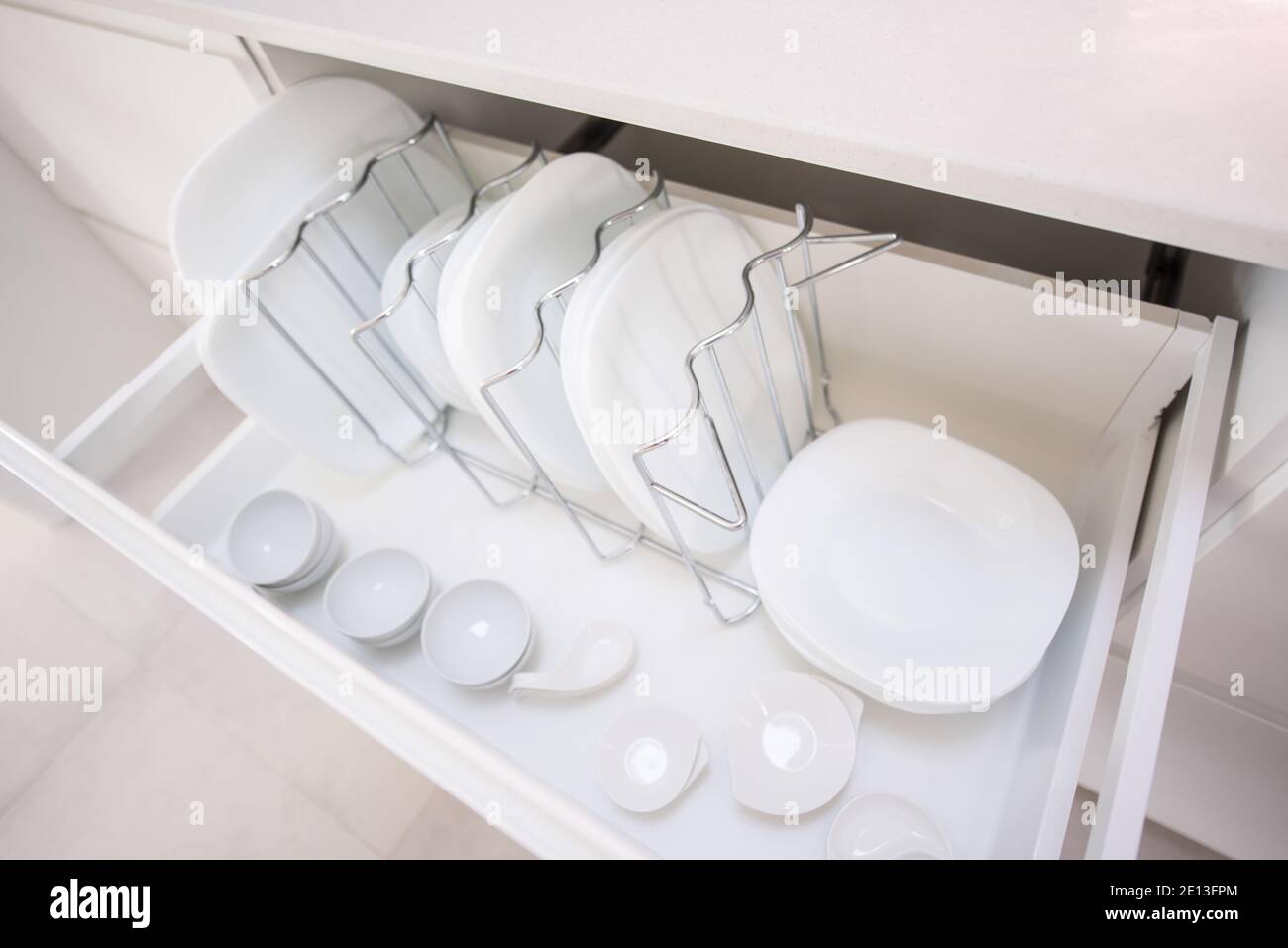 Plates in a kitchen drawer Stock Photo Alamy