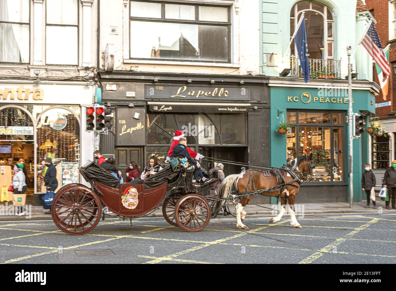 Santa Claus riding Christmas horse carriage for kids in Dublin city centre. Stock Photo