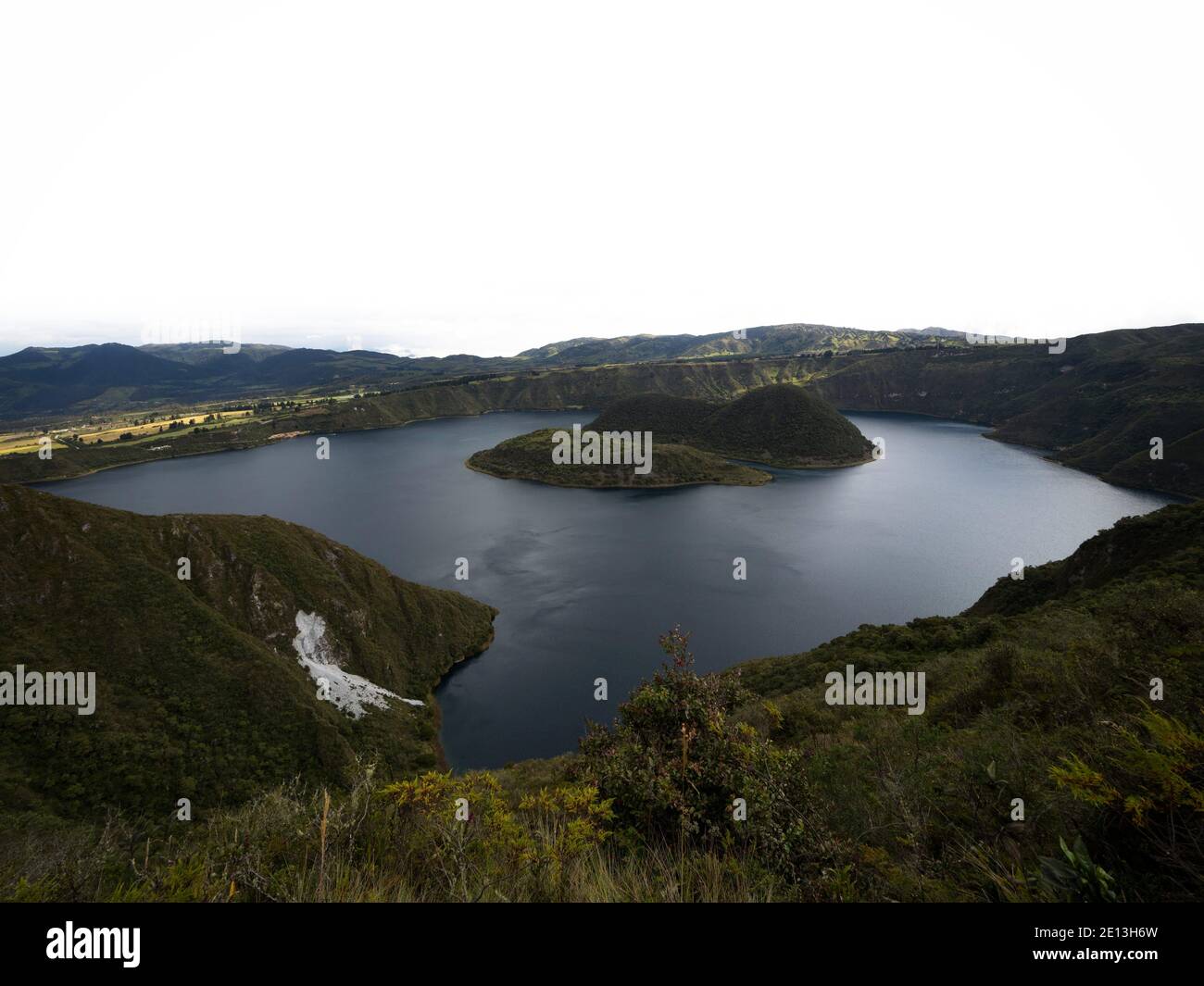 Panoramic wide angle view of Cuicocha caldera crater lake rainbow guinea pig kuykucha kuychikucha Cotacachi volcano in Cordillera Occidental andes Ota Stock Photo