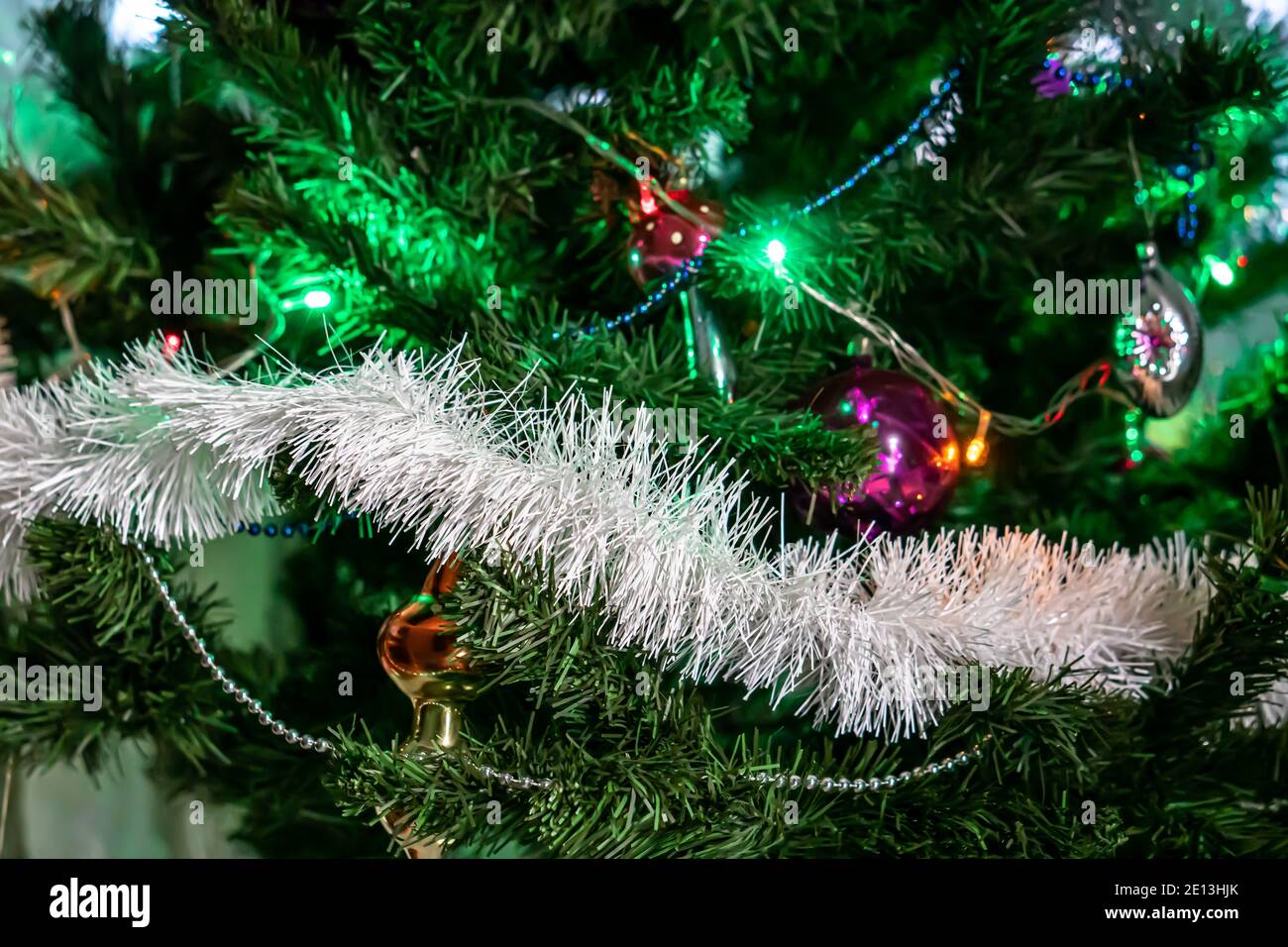 Christmas spruce decorated with garlands, lights and toys Stock Photo