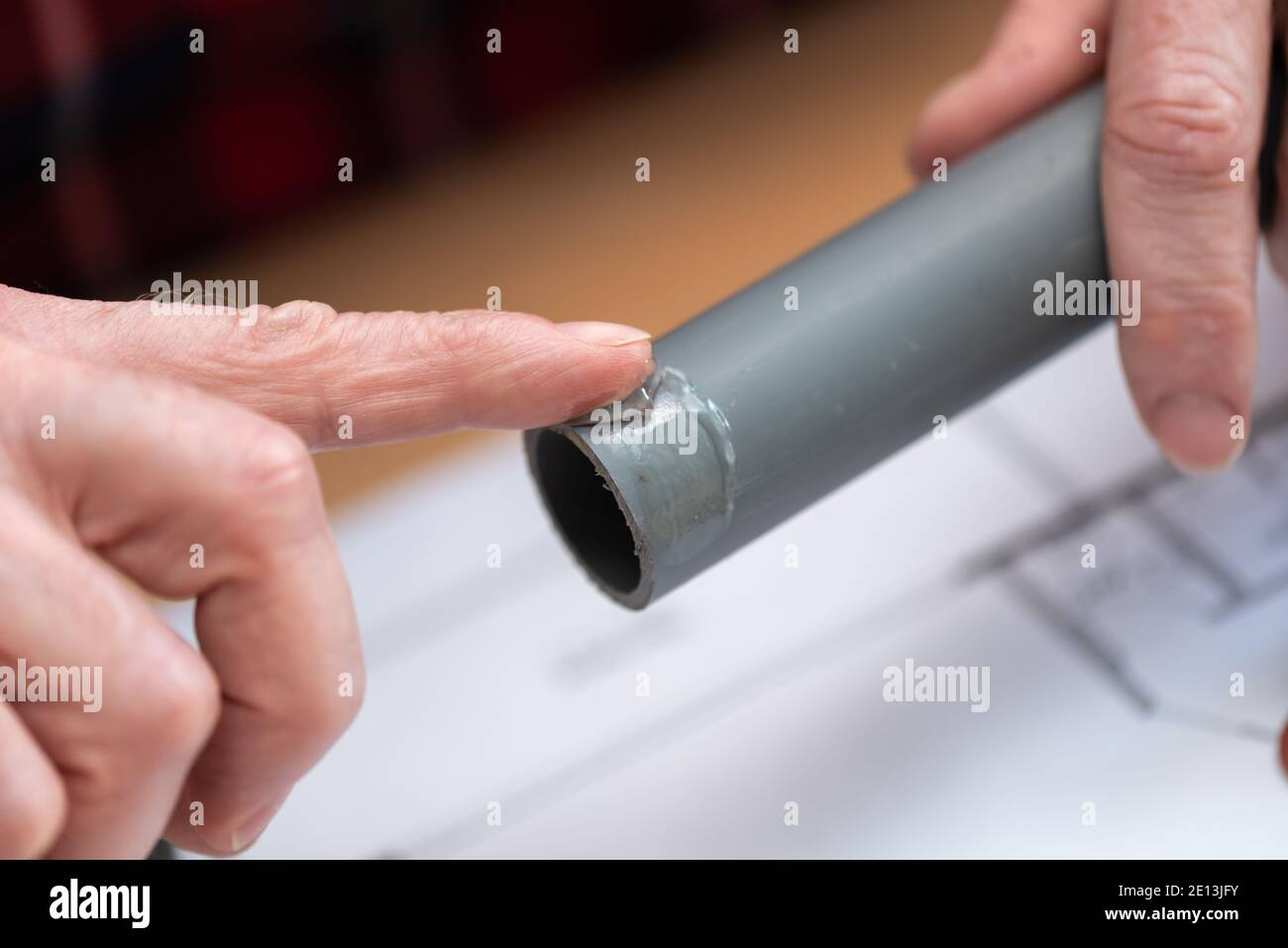 Plumber putting glue on a pvc pipe Stock Photo Alamy