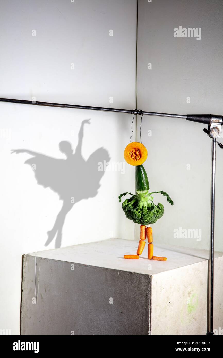 Ballerina made of broccoli, cucumbers. Flying food composition making  beautiful sportswoman drawing shadow on the white wall. Concept of sport,  nutrition, healthy lifestyle choice Stock Photo - Alamy