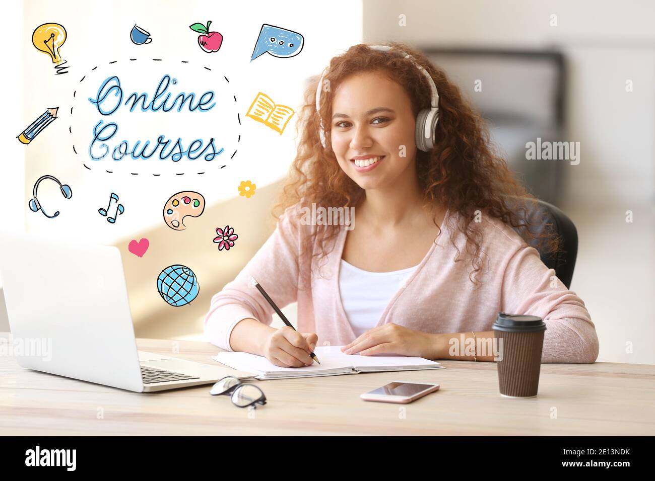 Text 'Online Courses' and young African-American student learning at home Stock Photo