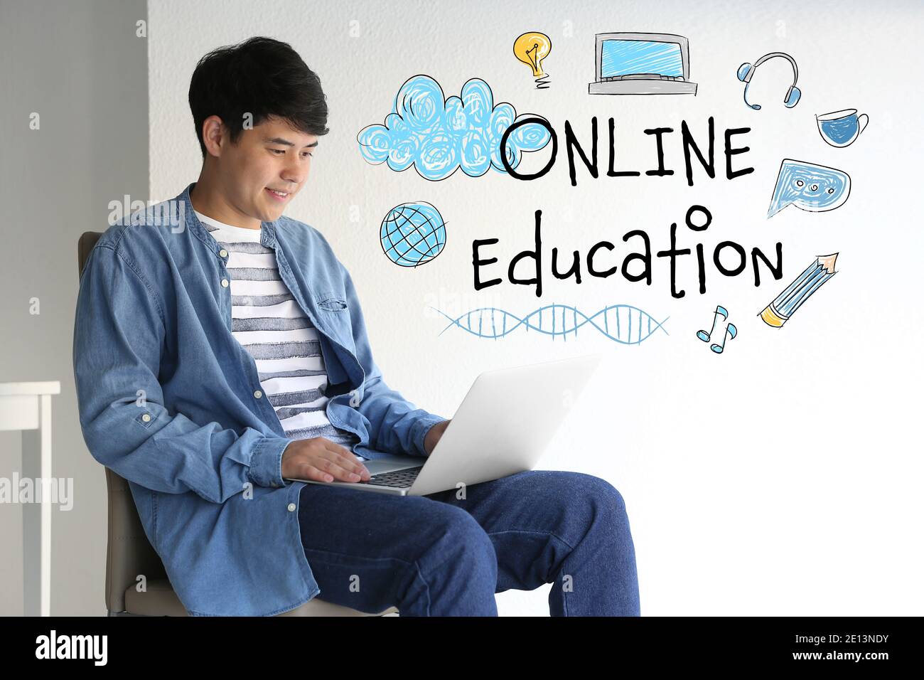 Young Asian student with laptop learning at home. Concept of online education Stock Photo
