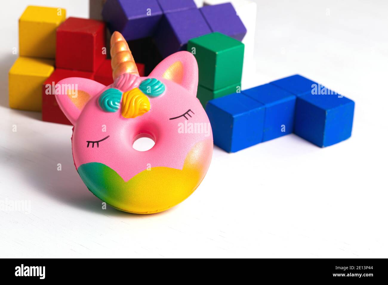 Children toys wooden colorful blocks and squash antistress toy donut unicorn  on white background Stock Photo - Alamy