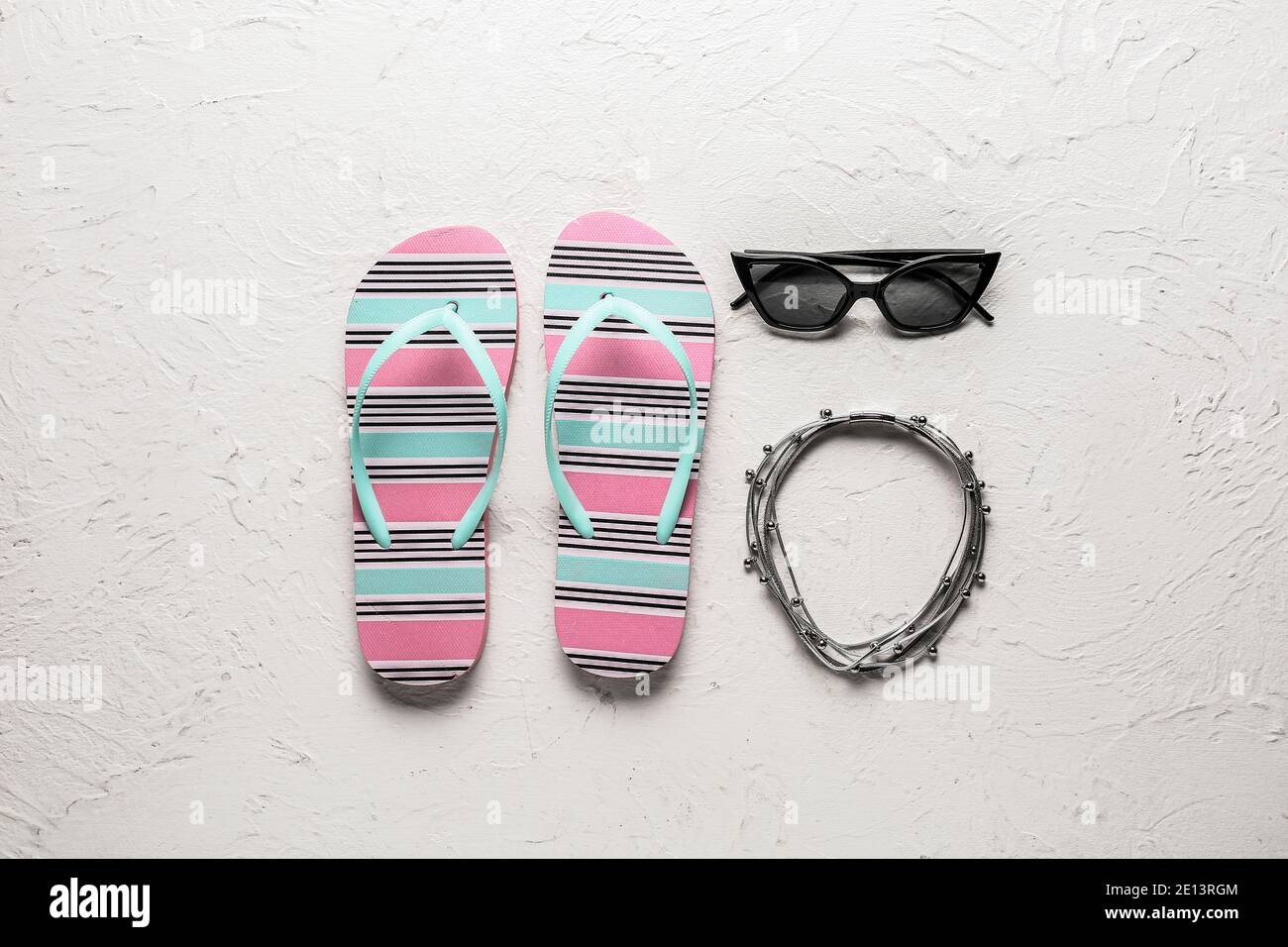 Stylish flip-flops and sunglasses on white background Stock Photo - Alamy