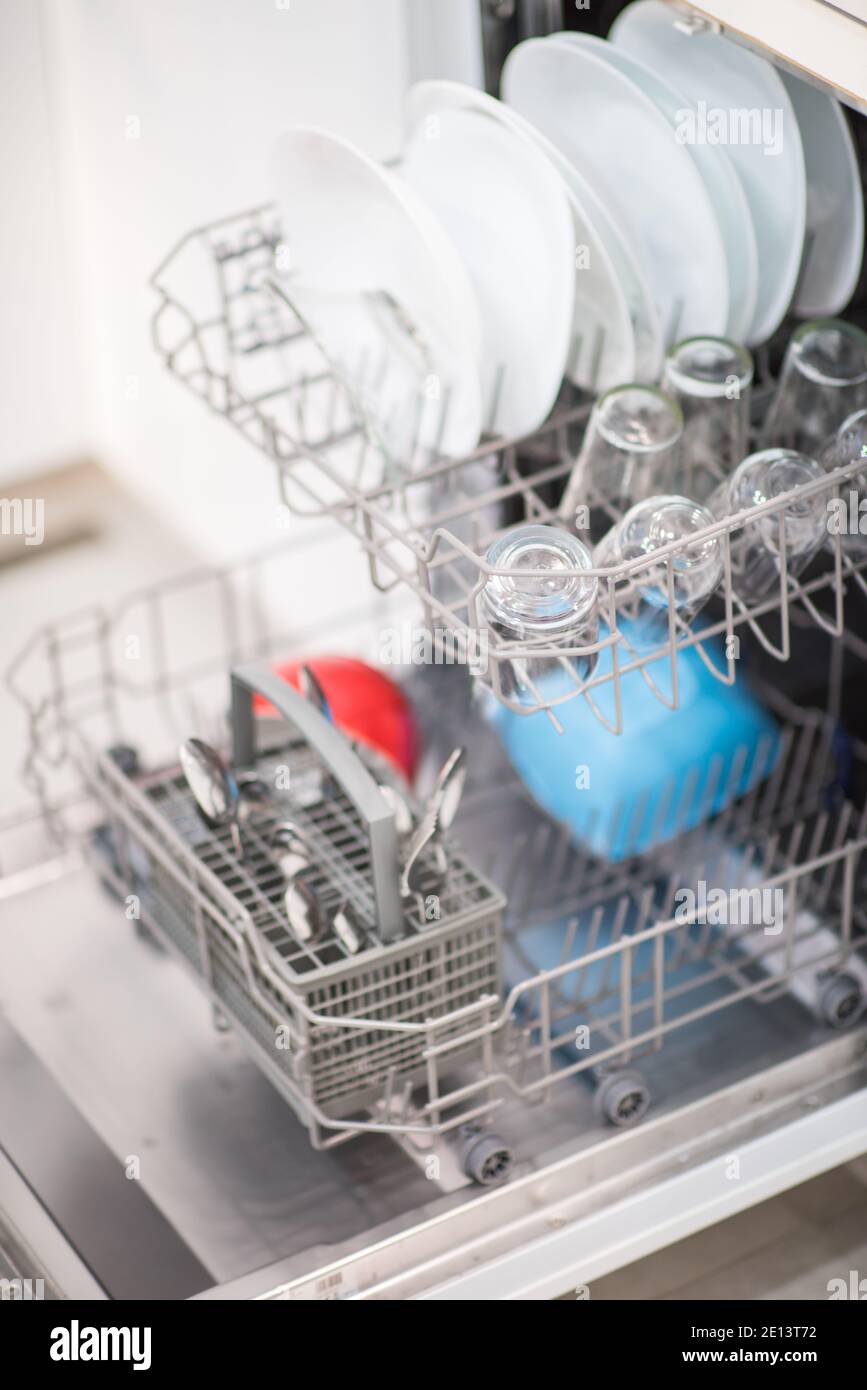 Open dishwasher with clean glass and dishes Stock Photo Alamy