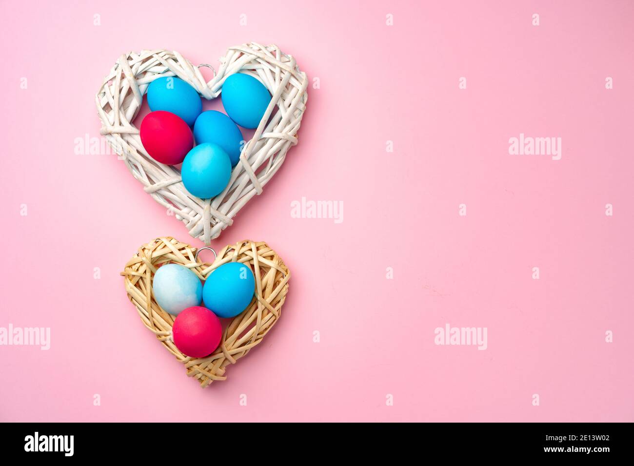 Painted Easter eggs in decorative nest on pink background Stock Photo ...