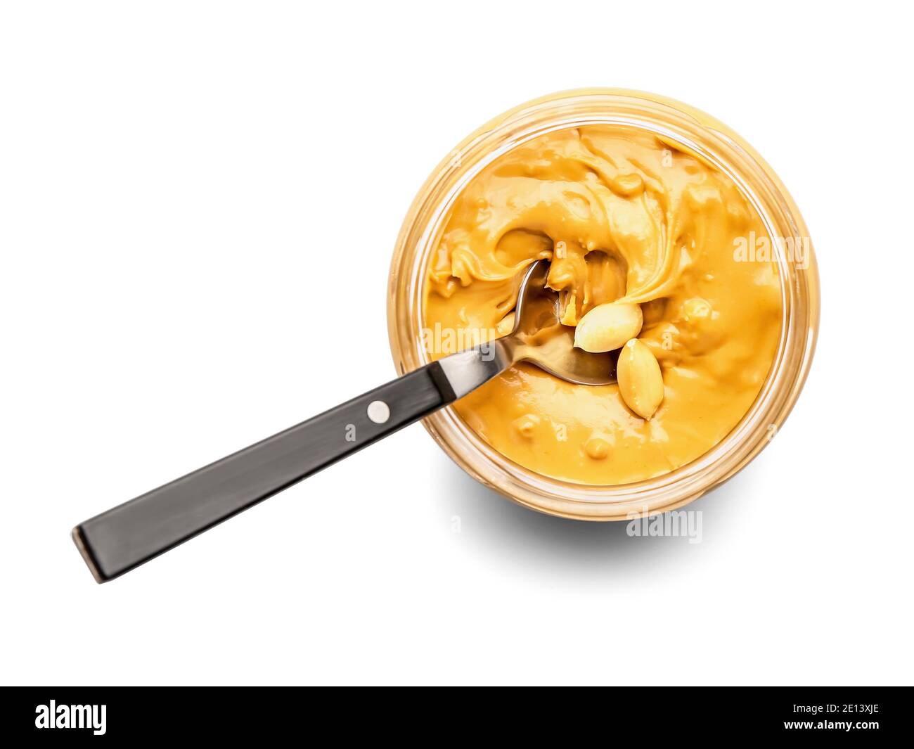 Jar and spoon with tasty peanut butter on white background Stock Photo ...