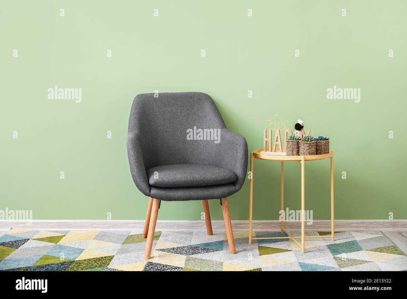 Modern interior of room with armchair and table Stock Photo - Alamy
