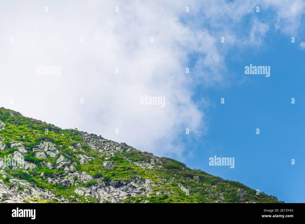 Blue sky and clouds over the rocks, beautiful cloud landscape over mountain range Stock Photo