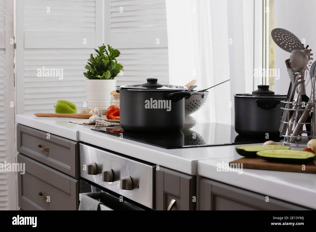 Cooking pots on electric stove in kitchen Stock Photo Alamy