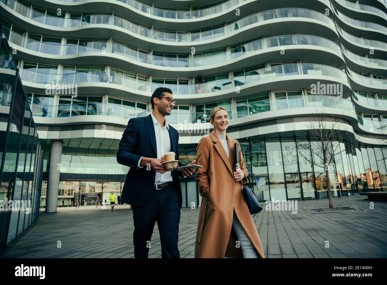 Business colleagues walking together to work discussing new collaboration project  Stock Photo
