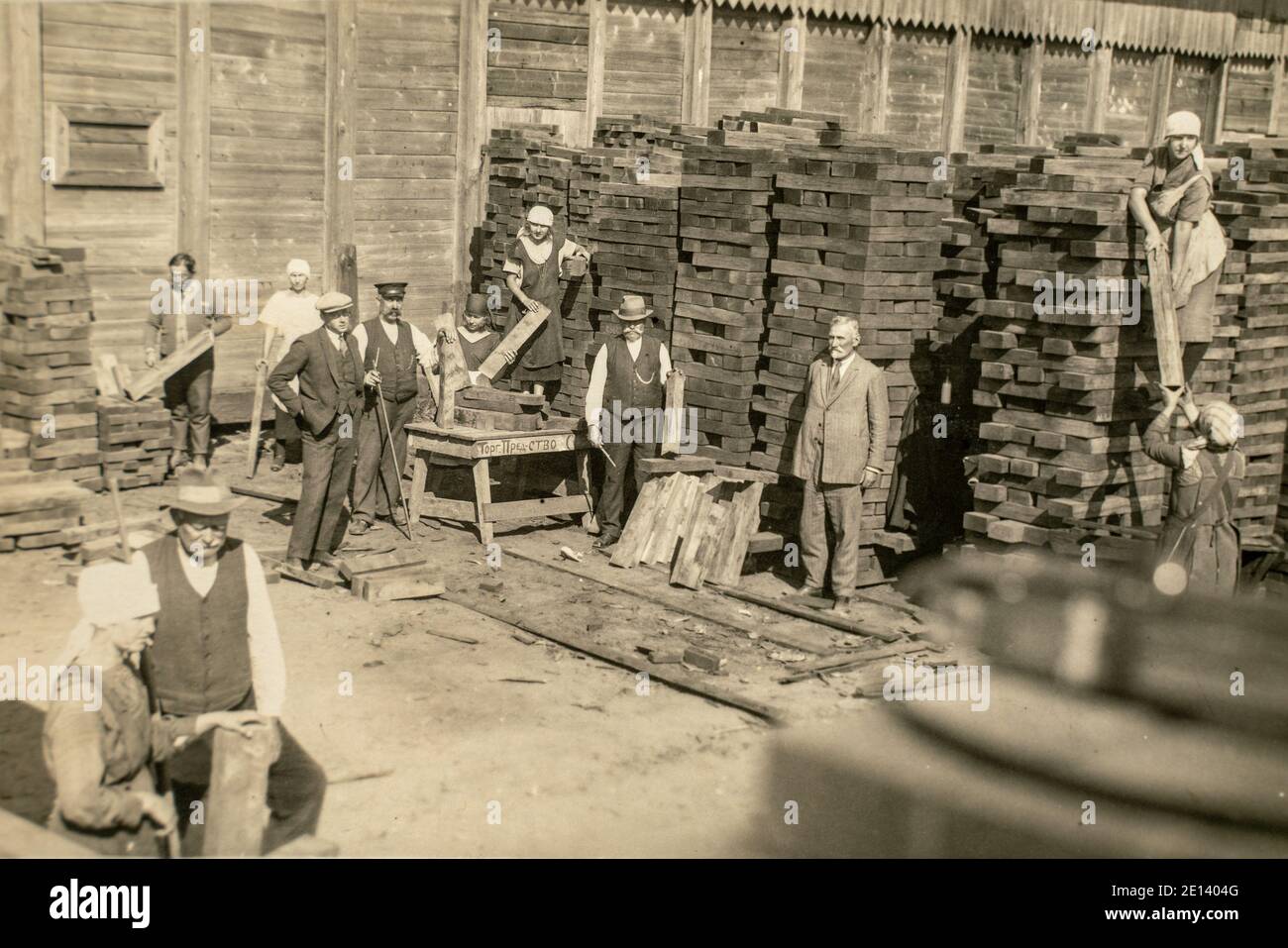 RUSSIA - CIRCA 1920s: Vintage archive photo of business owners managers and workers in rail sleepers factory. Sawmill Stock Photo