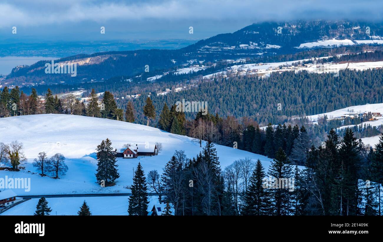 Holiday Home in the Austrian mountains with view to lake of Constance. snowy landscape. Ferienhaus in Ammenegg, verschneite Landschaft mit Bodensee Stock Photo