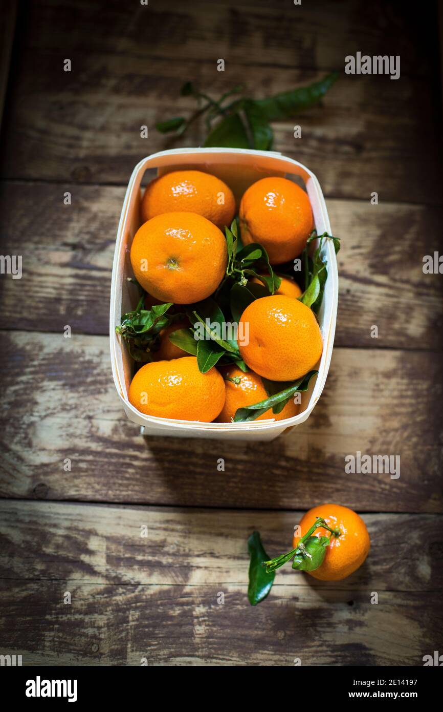 Several Mandarin Oranges On A Wooden Table Stock Photo