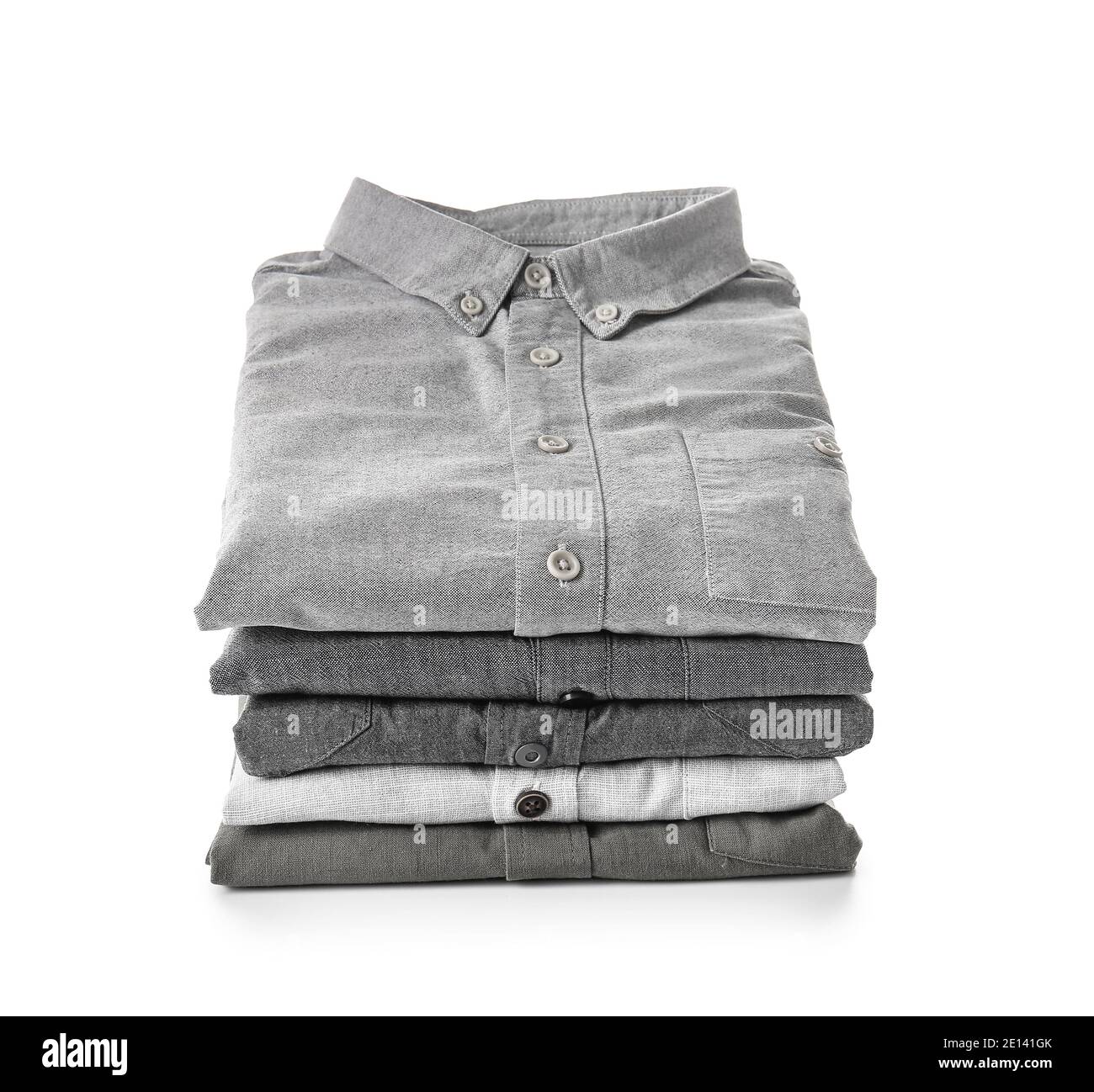 Stack of folded male shirts on white background Stock Photo - Alamy