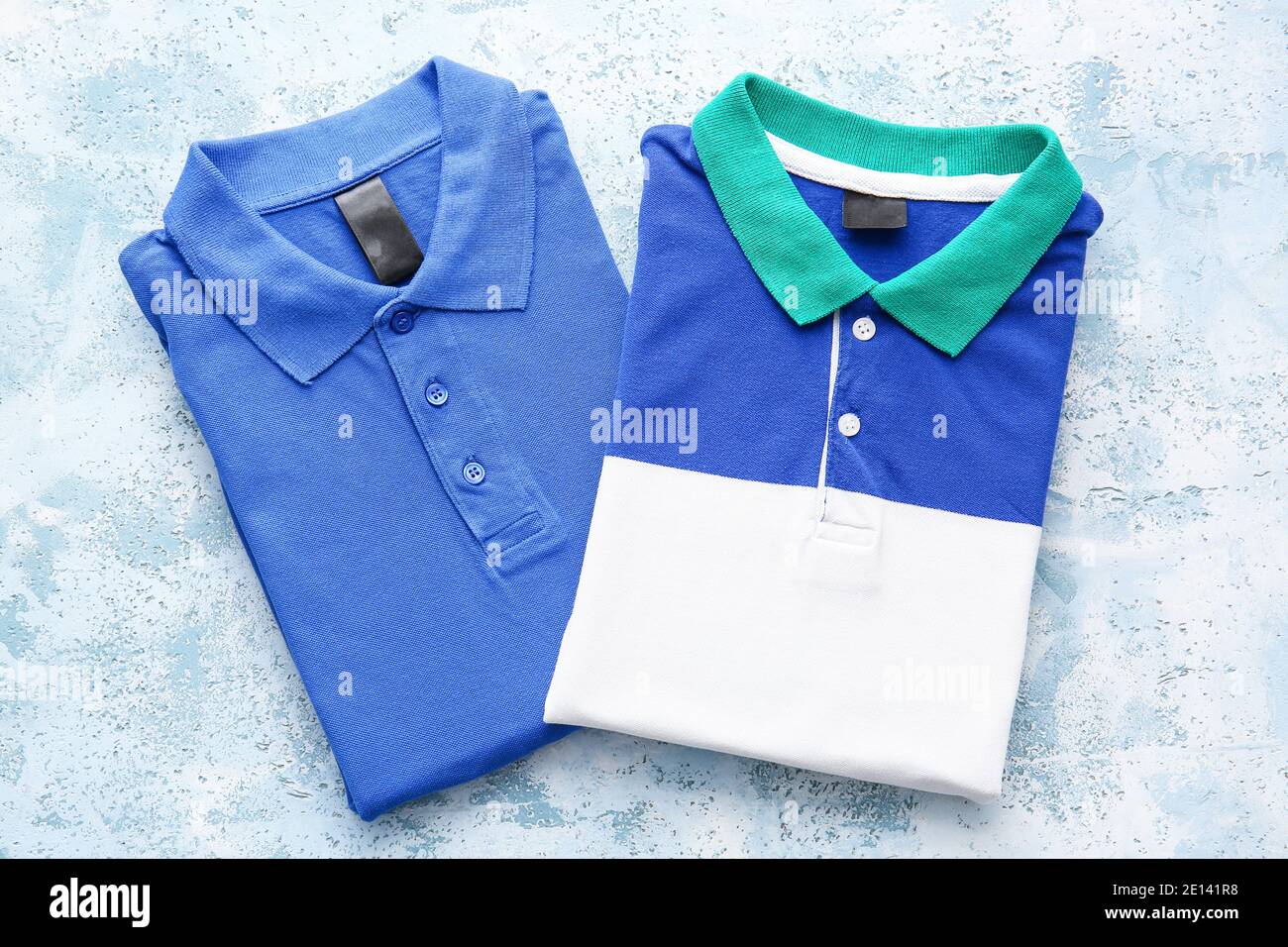 Folded polo shirts on light background Stock Photo - Alamy