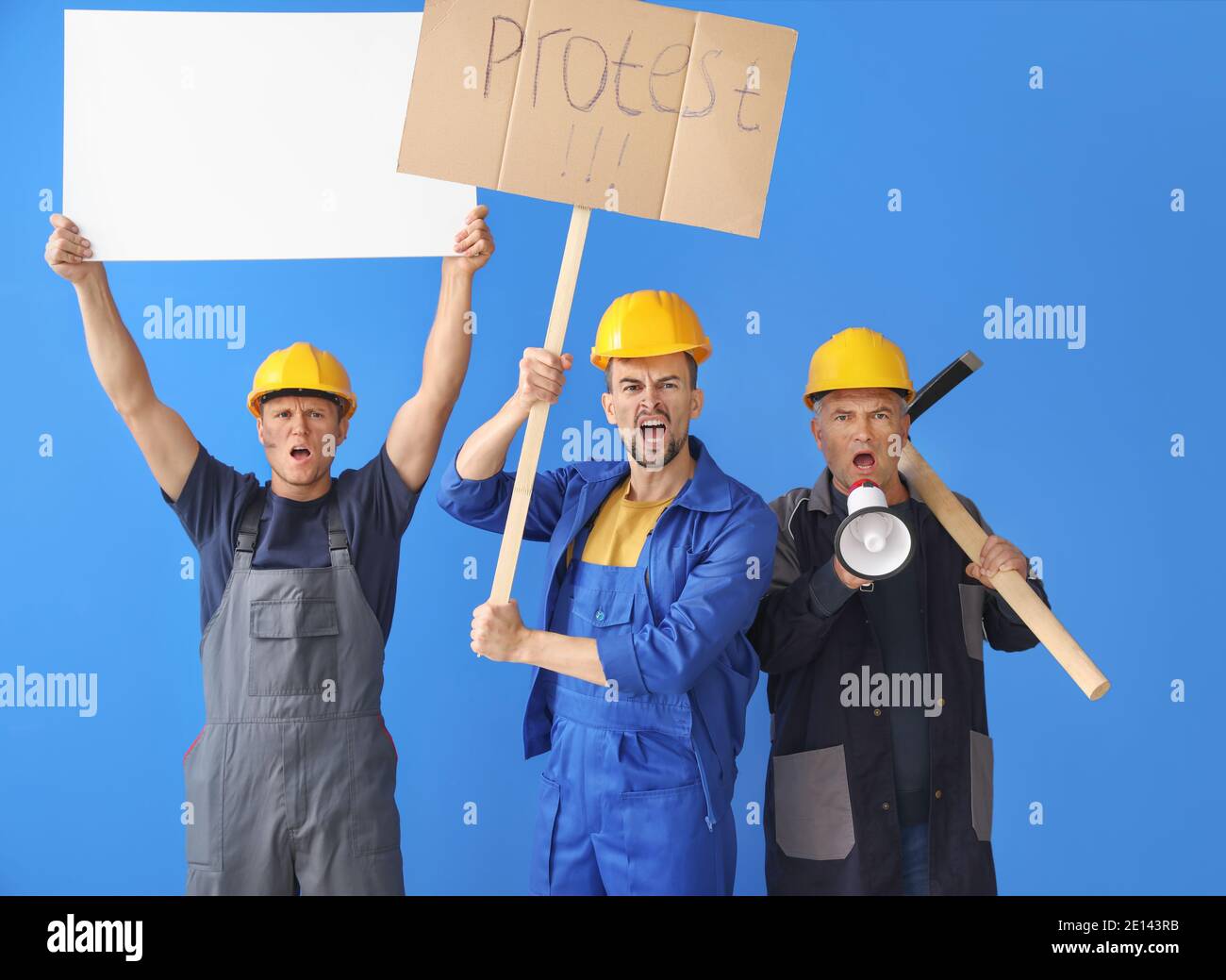 Protesting miner men with placards on color background Stock Photo