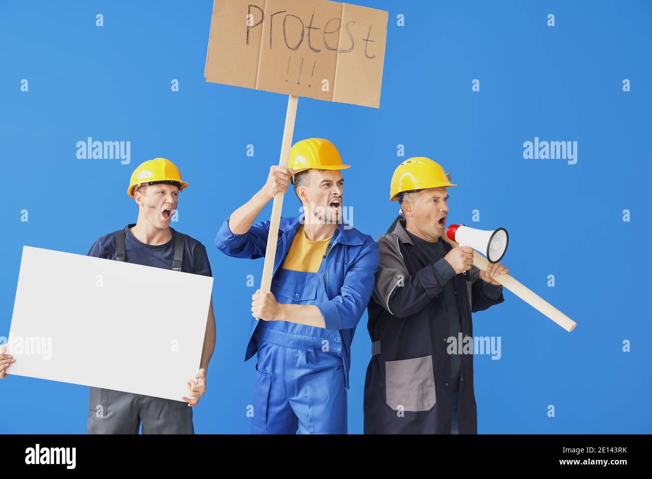 Protesting miner men with placards on color background Stock Photo