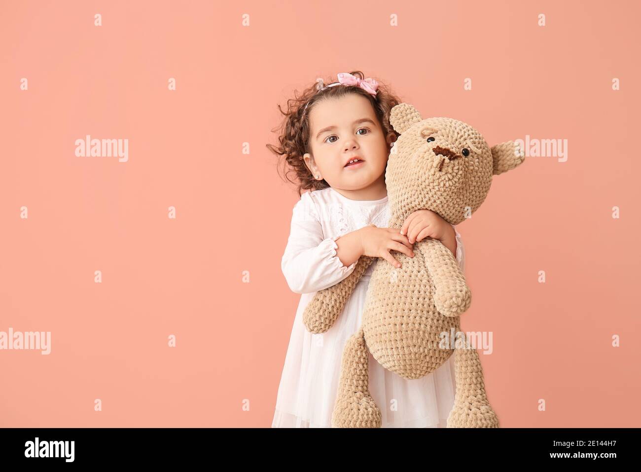 Cute baby girl with teddy bear on color background Stock Photo - Alamy