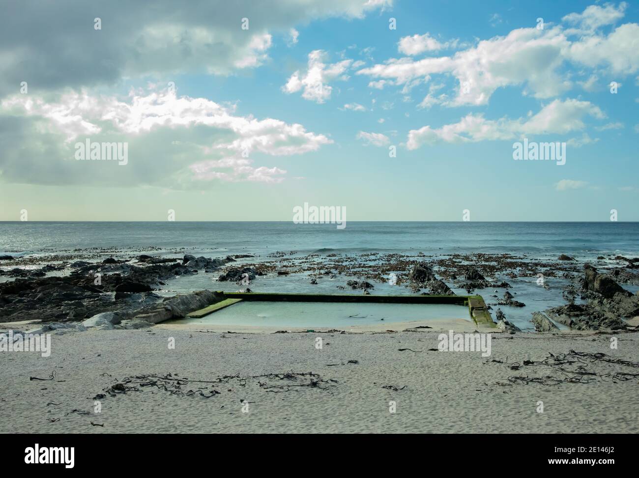 Sea Point, Cape Town, South Africa - 10/09/20 Clouds hiding the sun. Shot of a clear unoccupied tidal pool. Stock Photo