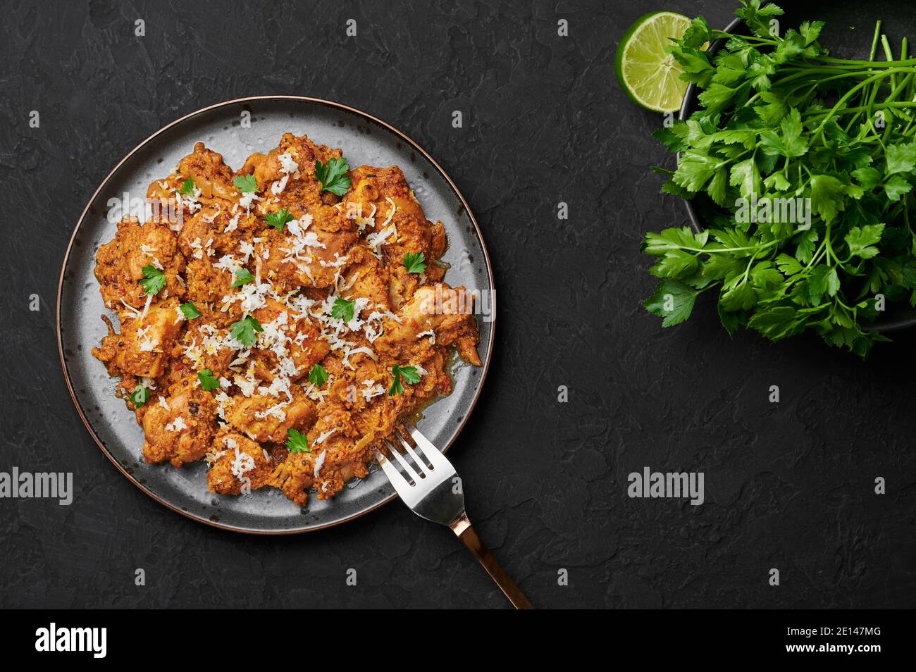 Mangalorean Chicken Sukka on black plate on dark slate table top. Indian  cuisine coconut curry dish. Asian food and meal. Top view Stock Photo -  Alamy