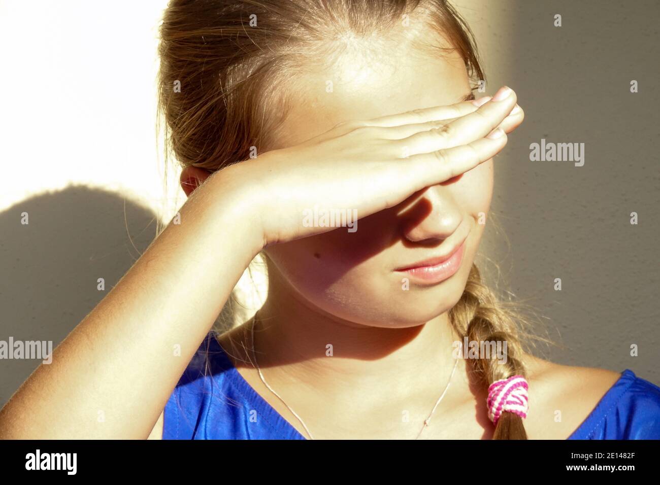 Teenage girl shades her eyes Stock Photo