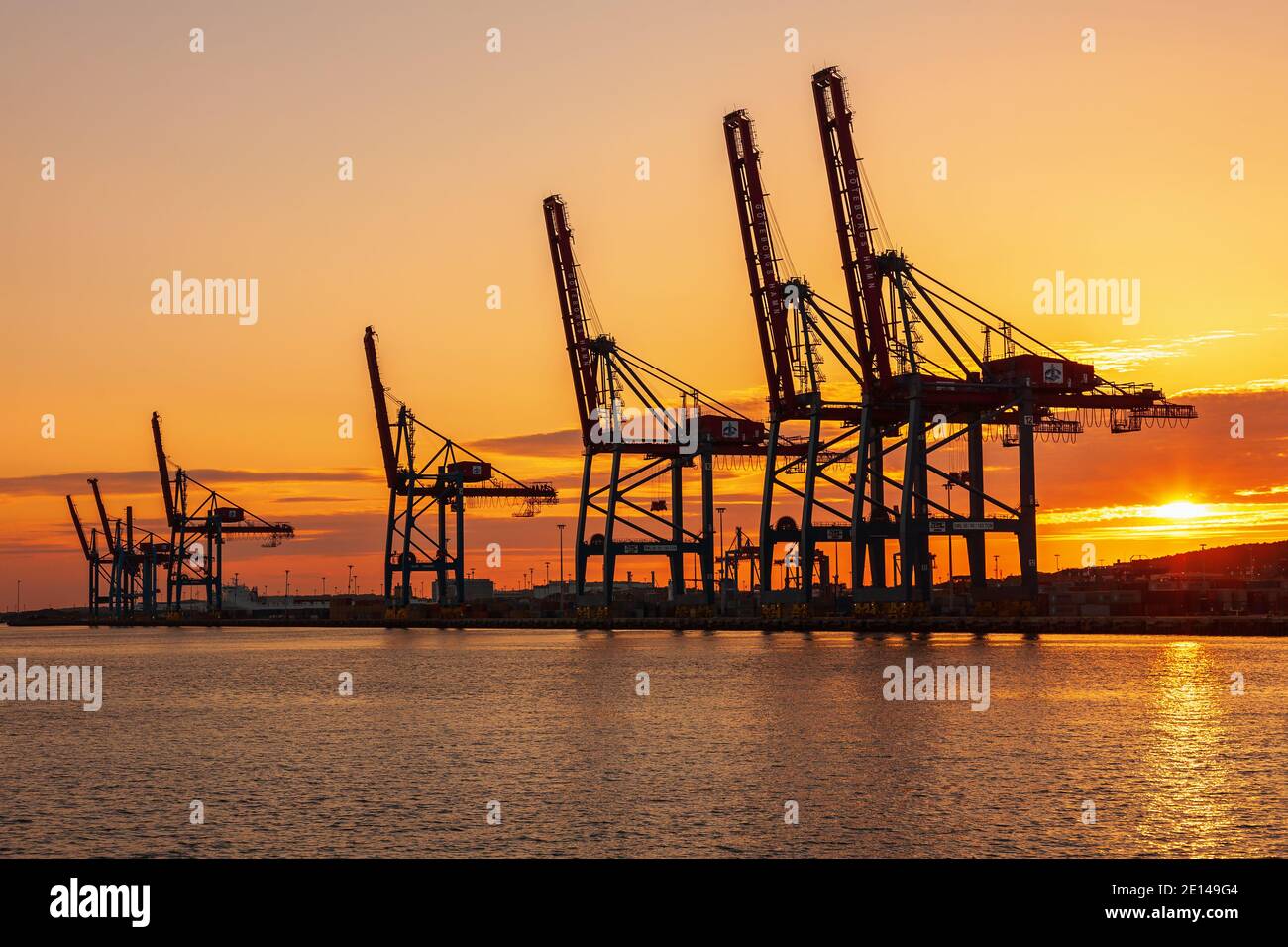 Seaport with container cranes at a beautiful sunset Stock Photo