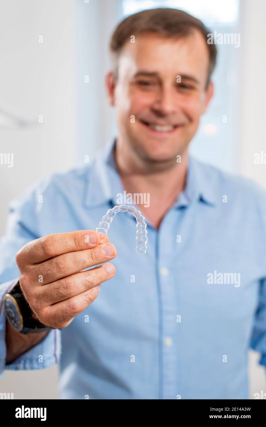 Man adjusting transparent aligners hi-res stock photography and images ...