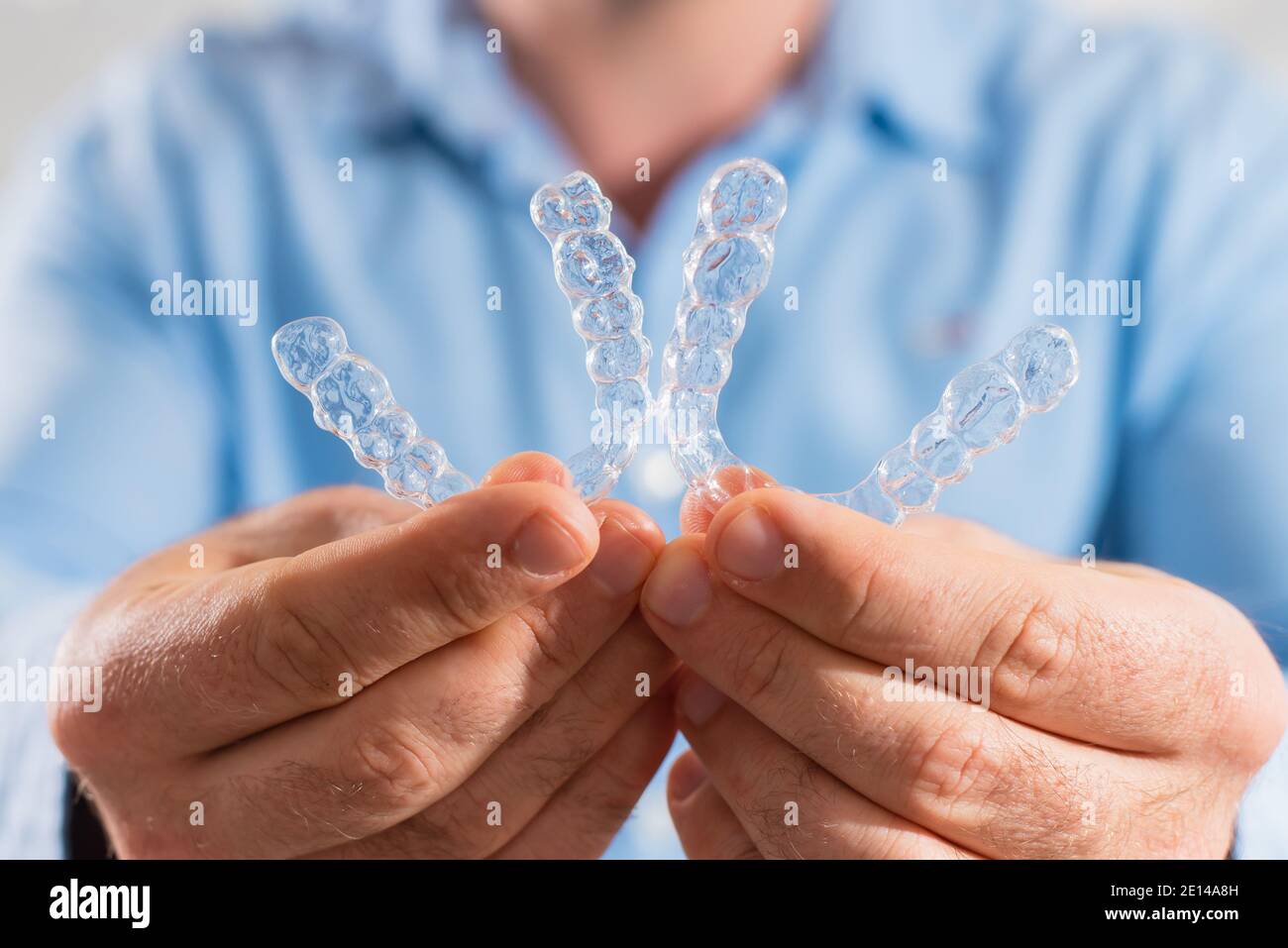 The dentist doctor holds transparent aligners in his hands Stock Photo ...