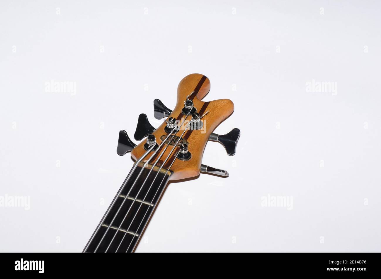 head and strings of a bass guitar with white background Stock Photo