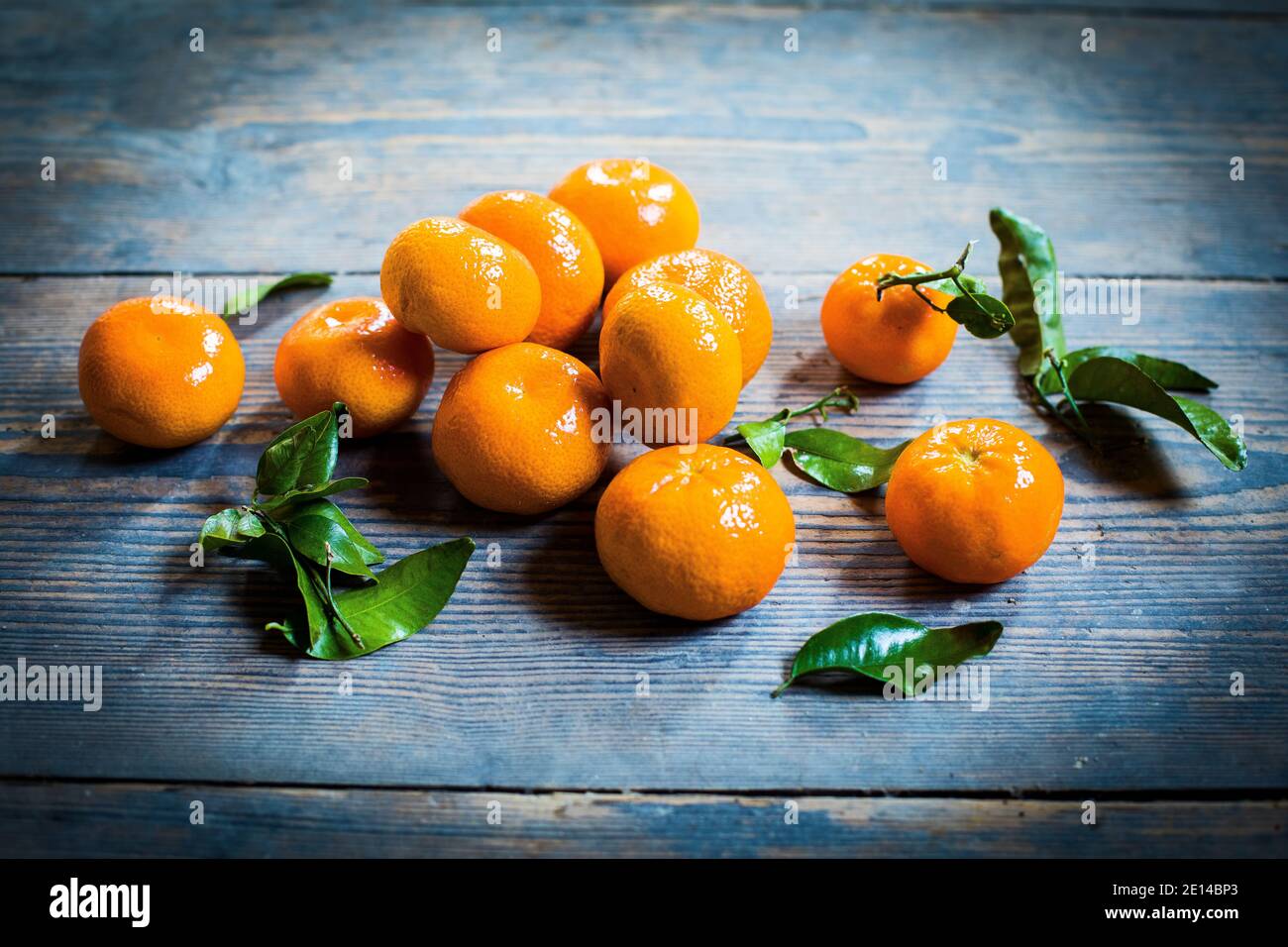 Several Mandarin Oranges On A Wooden Table Stock Photo