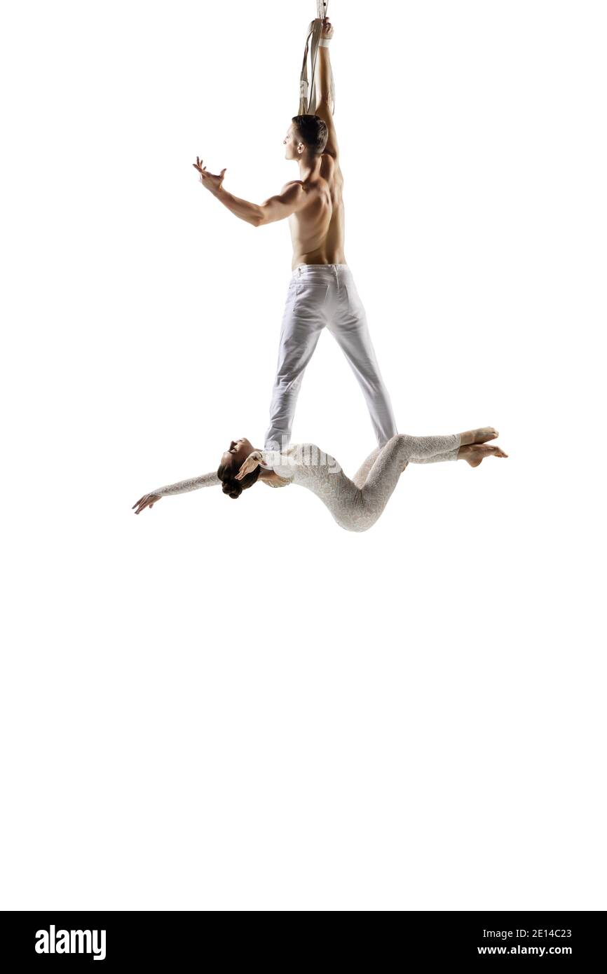 Flexible. Couple of acrobats, circus athletes isolated on white studio
