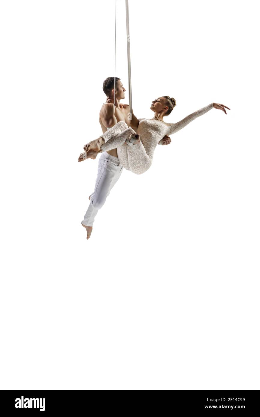 Rescuing. Couple of acrobats, circus athletes isolated on white studio ...