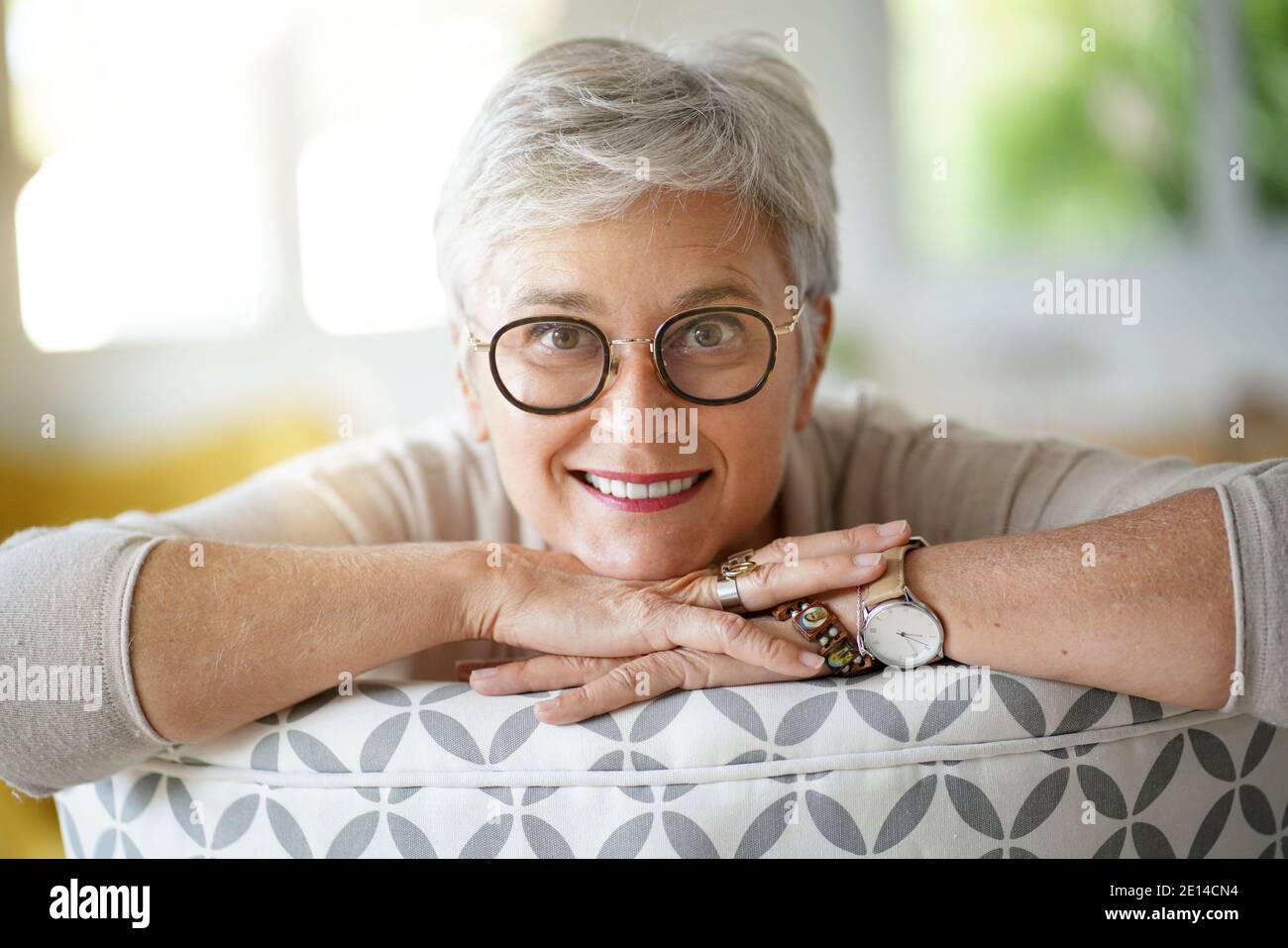 Portrait Of A Beautiful Smiling 55 Year Old Woman With White Hair Stock