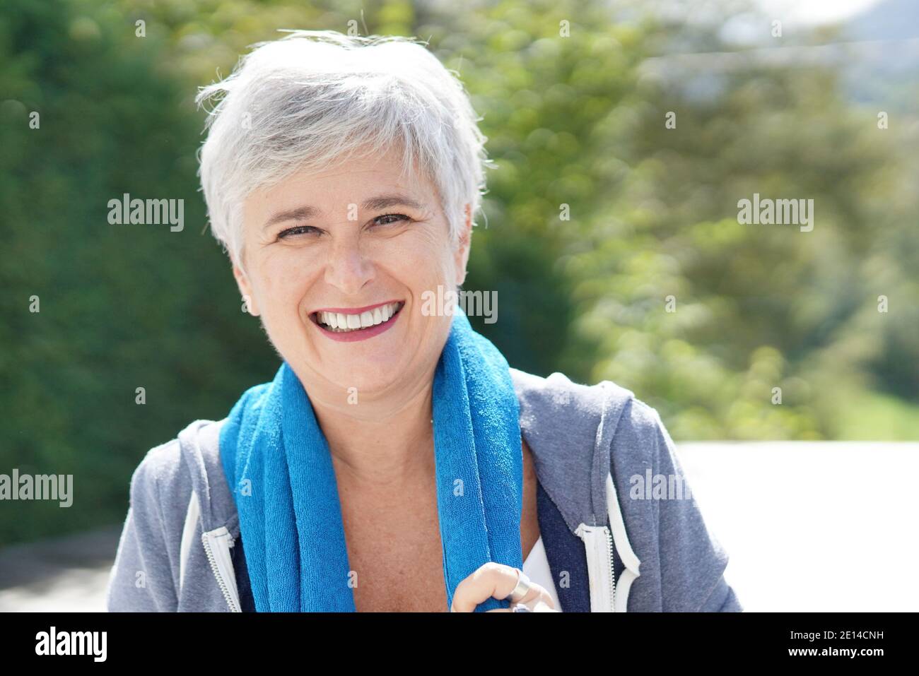 Cheerful senior woman exercising outside on a sunny day Stock Photo