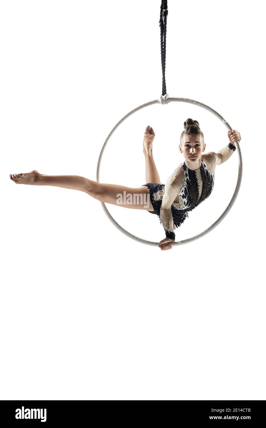 Youth. Young female acrobat, circus athlete isolated on white studio ...
