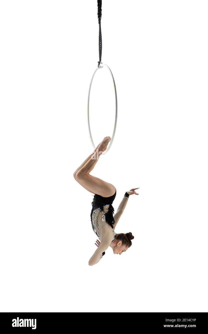 Dangerous. Young female acrobat, circus athlete isolated on white ...