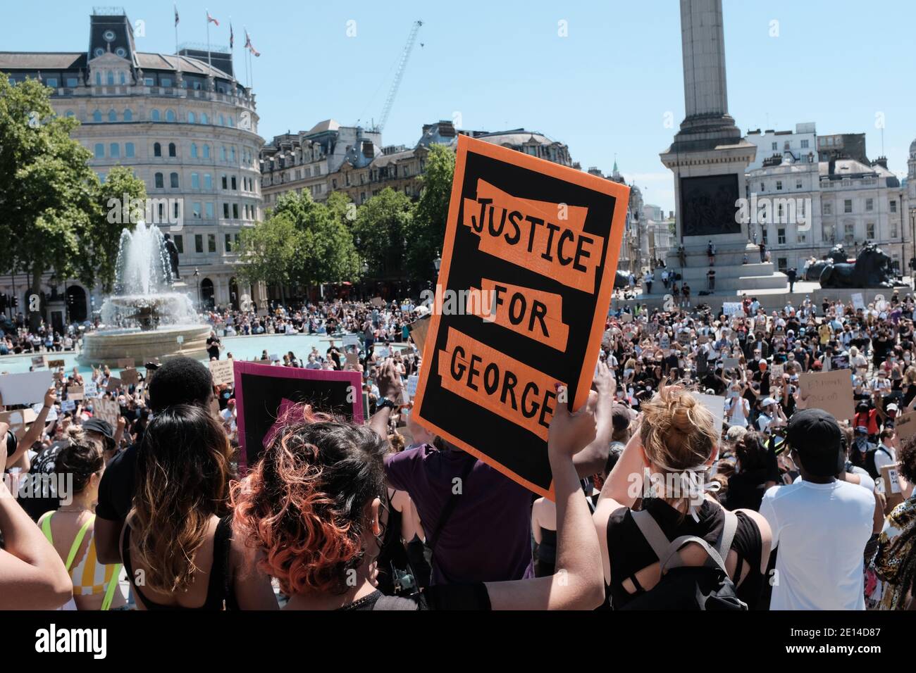 LONDON - 31st May 2020: A protester on trafalgar square holds a sign that reads 'Justice for George'. Shortly after the death of George Floyd Stock Photo