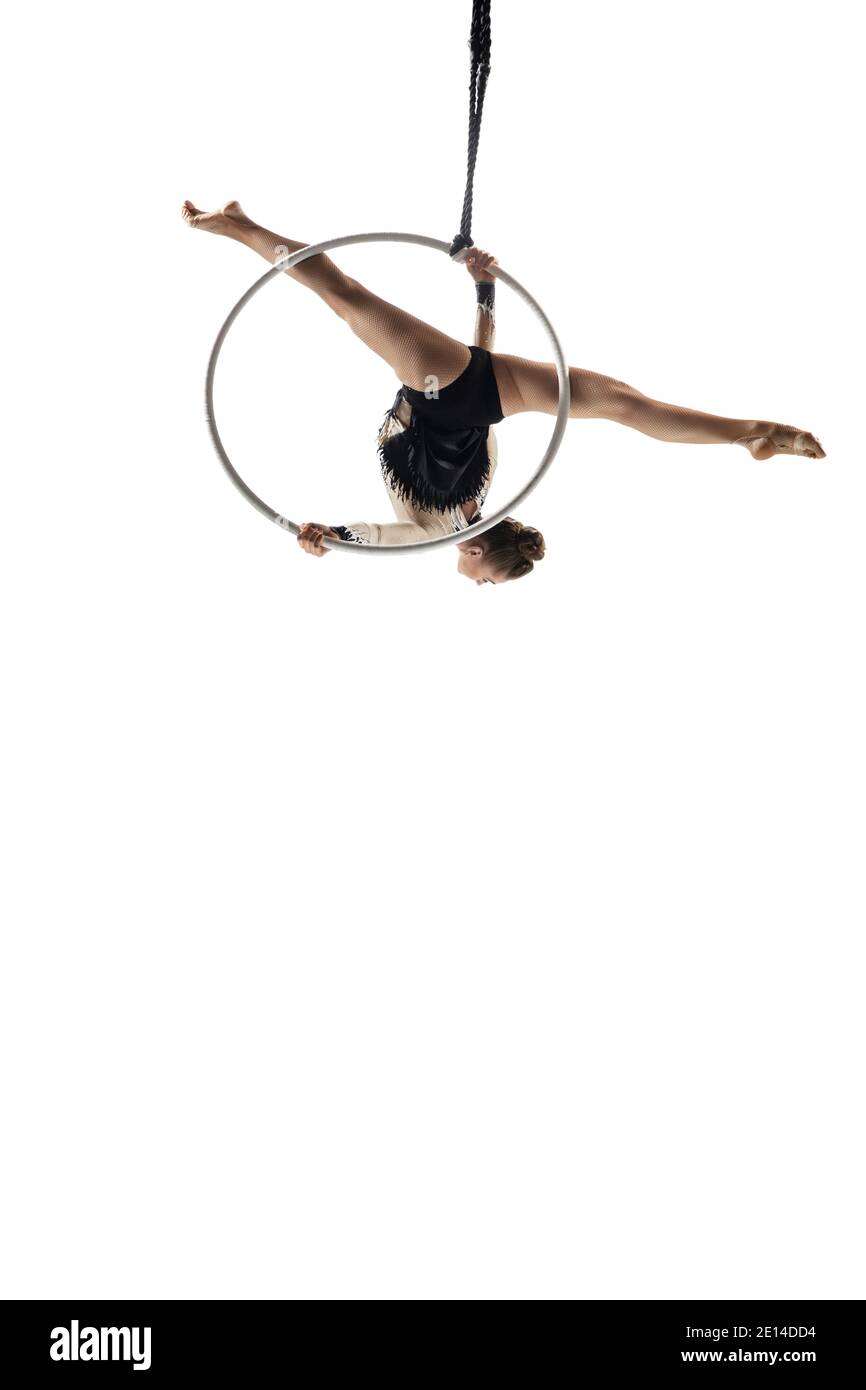 Speed. Young female acrobat, circus athlete isolated on white studio ...